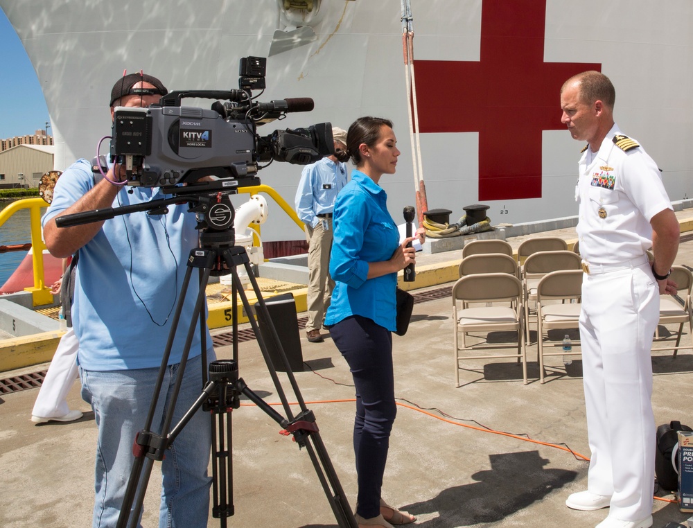Mission commander for Pacific Partnership 2015 speaks with a reporter from KITV news during a press conference