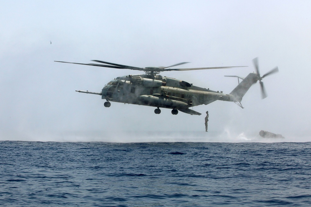 U.S. Marines go toe first from helicopters into the Gulf of Aden