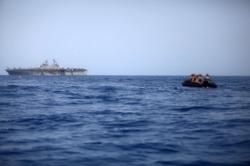U.S. Marines go toe first from helicopters into the Gulf of Aden