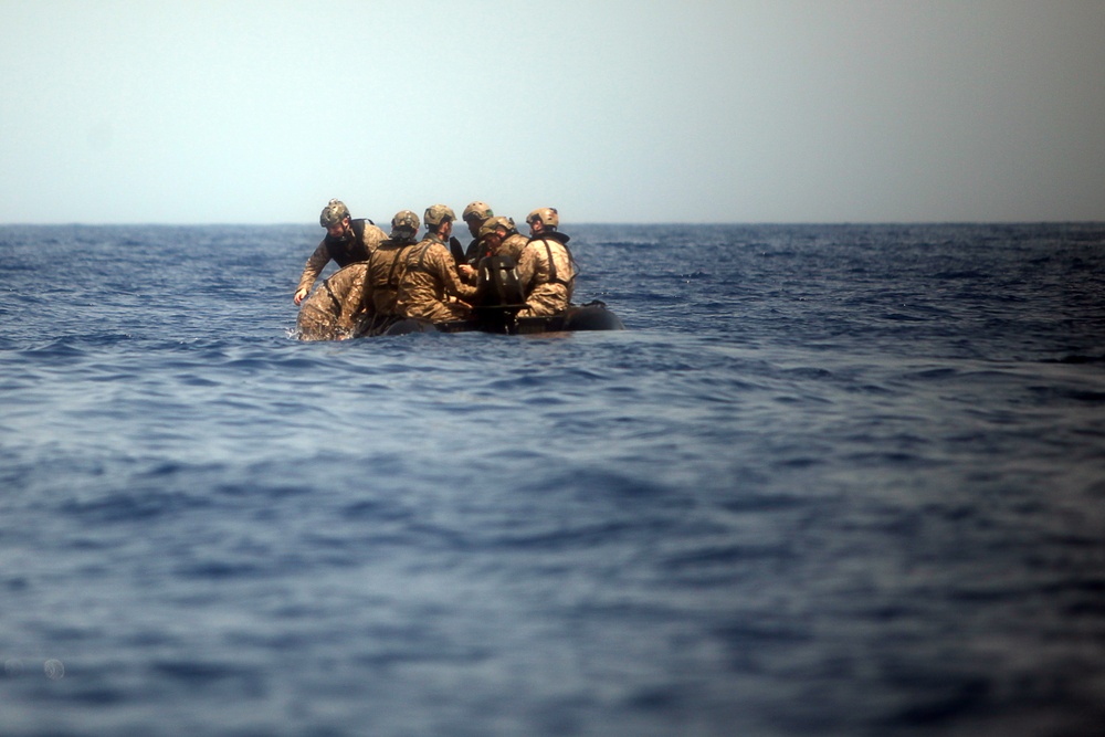 U.S. Marines go toe first from helicopters into the Gulf of Aden