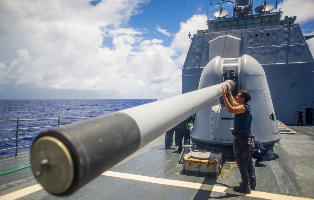 USS Antietam sailor cleans gun barrel