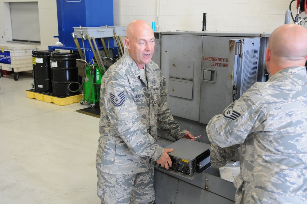 Tech. Sgt. Anthony Ballard and Tech. Sgt. Ryan Williams display a new module for a generator to be installed into a portable generator May 18