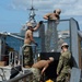 Sailors work to repair the floating dock next to the USS Arizona Memorial