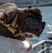 Sailor works to repair the floating dock next to the USS Arizona Memorial