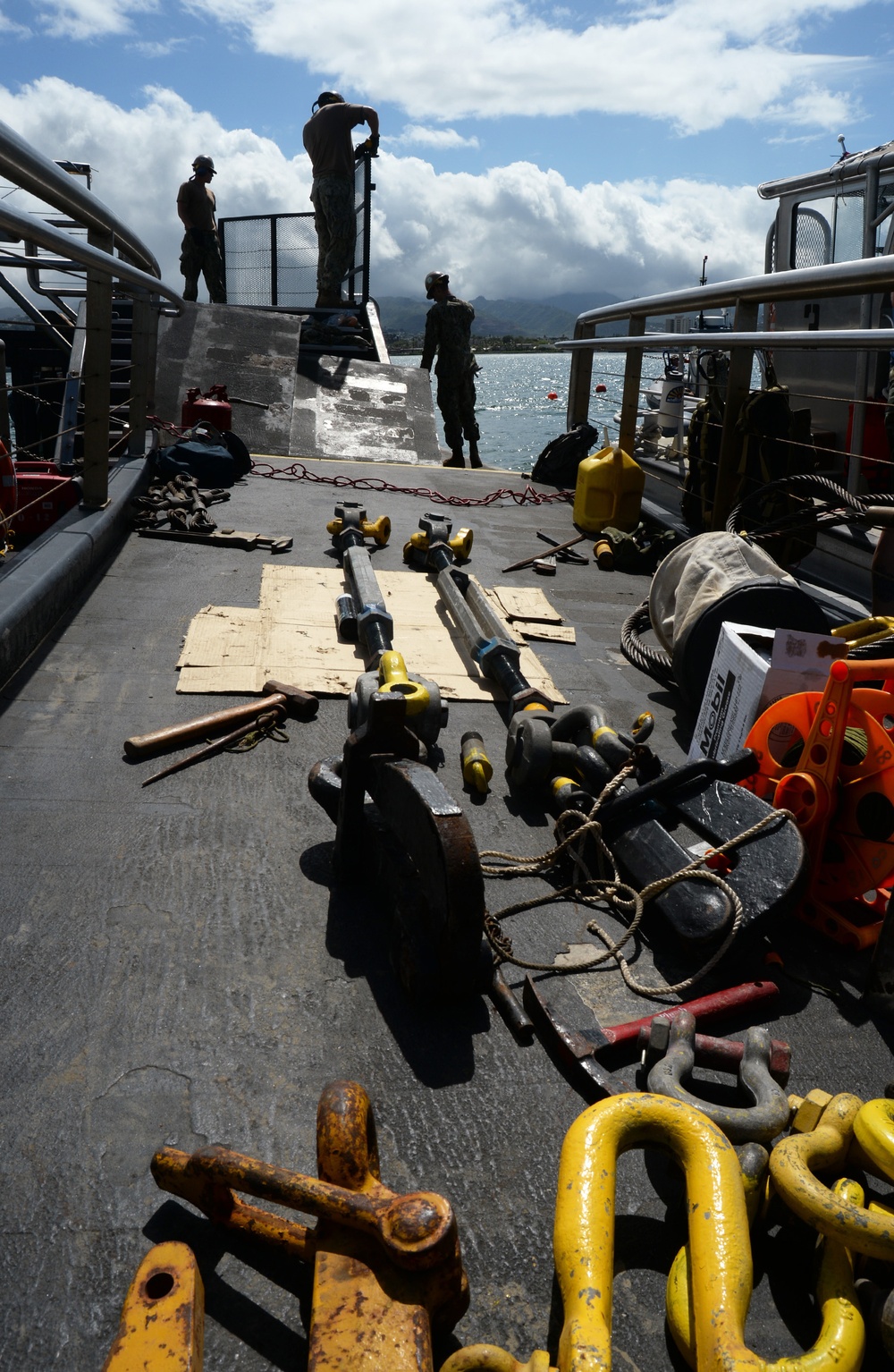 Sailors work to repair the floating dock next to the USS Arizona Memorial