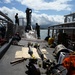 Sailors work to repair the floating dock next to the USS Arizona Memorial