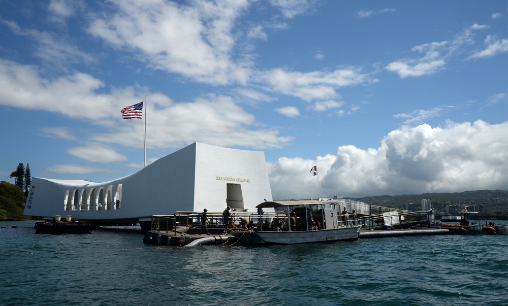 Sailors work to repair the floating dock next to the USS Arizona Memorial