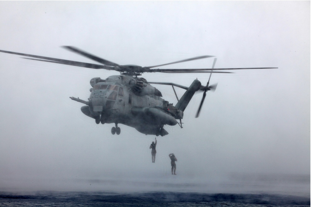 MRF Marines jump from a CH-53E Super Stallion during helo-cast training in the Gulf of Aden
