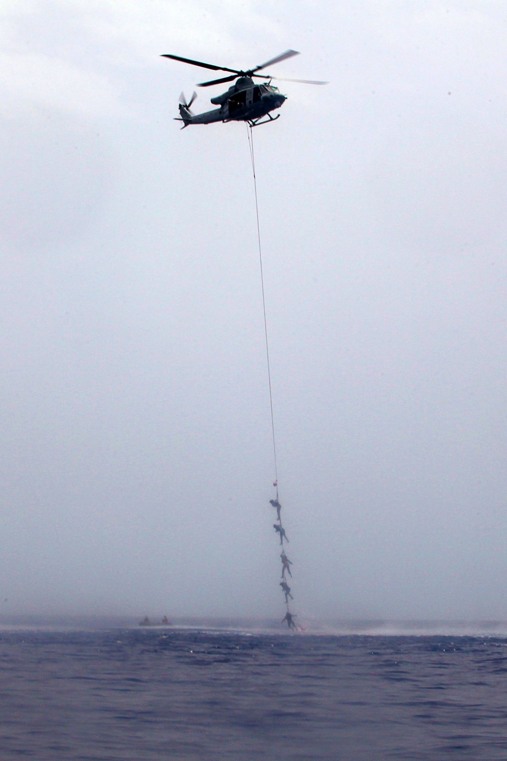 MRF Marines jump from a CH-53E Super Stallion during helo-cast training in the Gulf of Aden