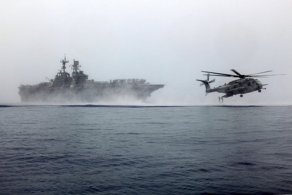 MRF Marines jump from a CH-53E Super Stallion during helo-cast training in the Gulf of Aden