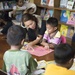 Pacific Partnership service members read to students in Kiribati