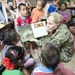 Pacific Partnership service members read to students in Kiribati