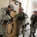 Security forces clear rooms during an active shooter exercise