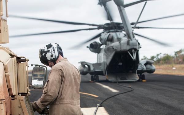 Marines with MRF-D  assist in the refueling of vehicles by helicopter