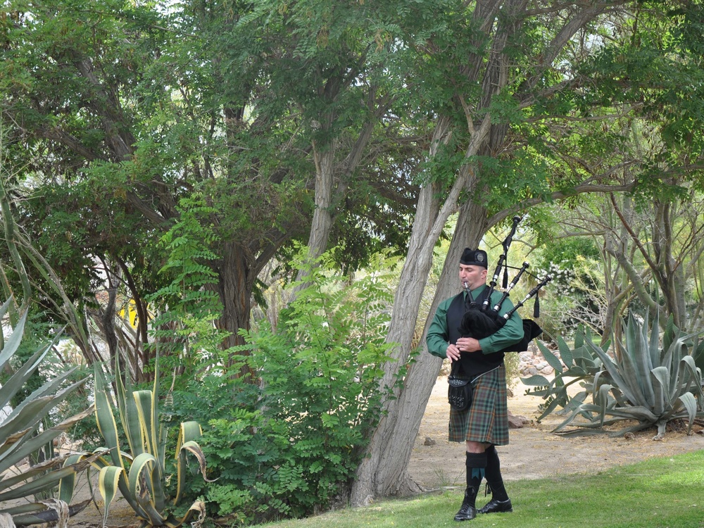 Bagpipes render Amazing Grace for a full chapel during memorial services for Lt. Levi Baker