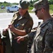 1st ID Re-enactment Group's first sergeant discusses World War II weapons with USSOCOM major