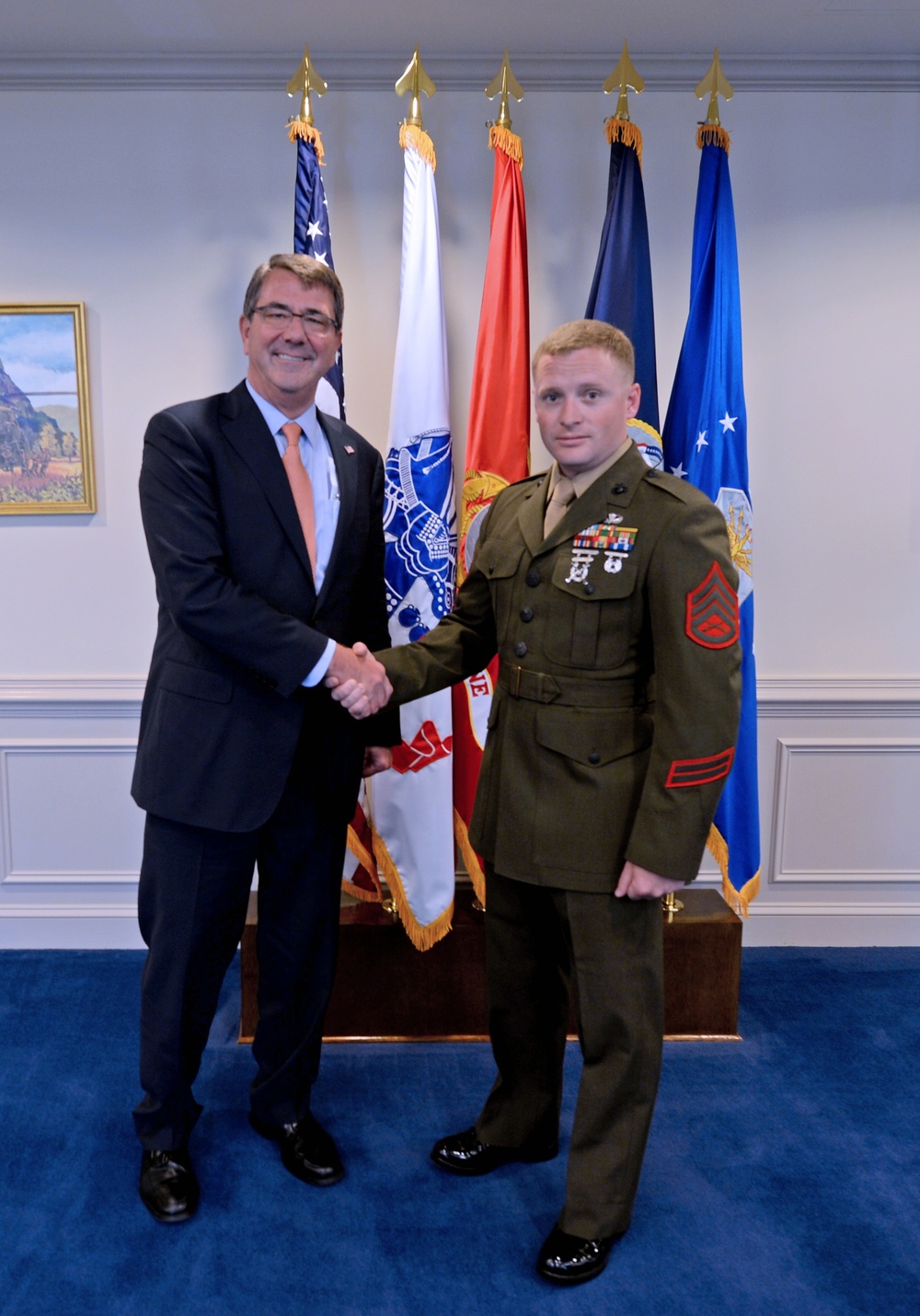 Secretary of defense takes a photo with the Junior Enlisted Service Member of the Year