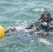 Navy diver moves buoy during POW/MIA recovery mission