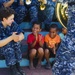 The Pacific Fleet Band entertains children in Savusavu, Fiji, during Pacific Partnership 2015