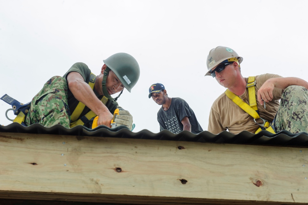 Military engineers from the US and Japan help build a children's classroom at Wailevu, Fiji