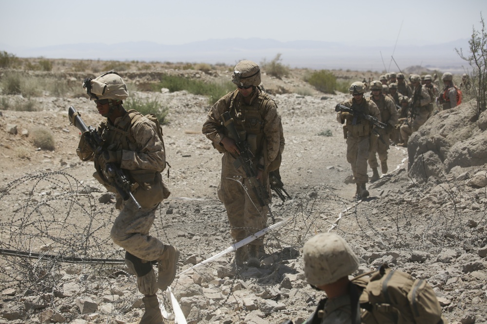 Marines move and shoot down range in cooperative exercise