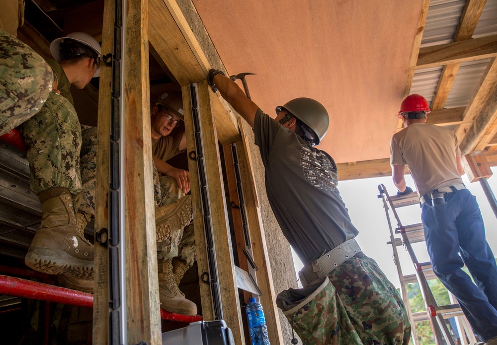 Engineers from US Air Force, Japan Ground Self Defense Force and Fiji military build a classroom during Pacific Partnership 2015