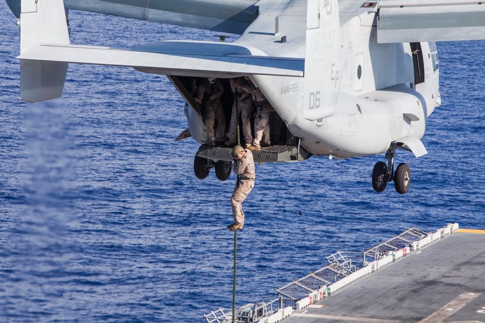 Marines practice fast roping on ship