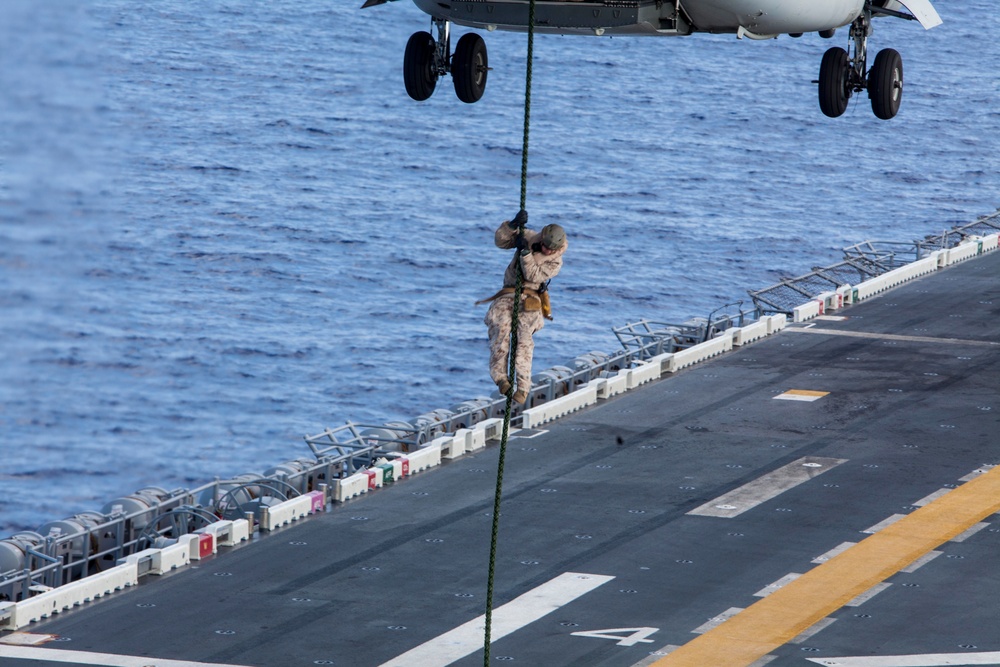 Marines practice fast roping on ship