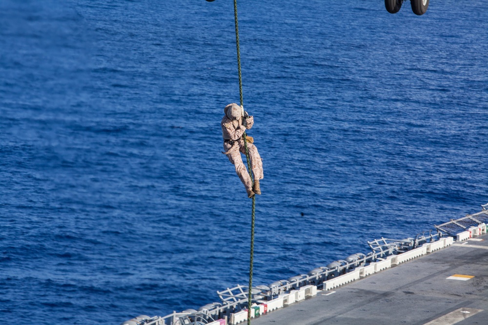 Marines practice fast roping on ship