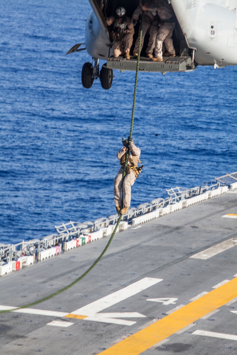 Marines practice fast roping on ship