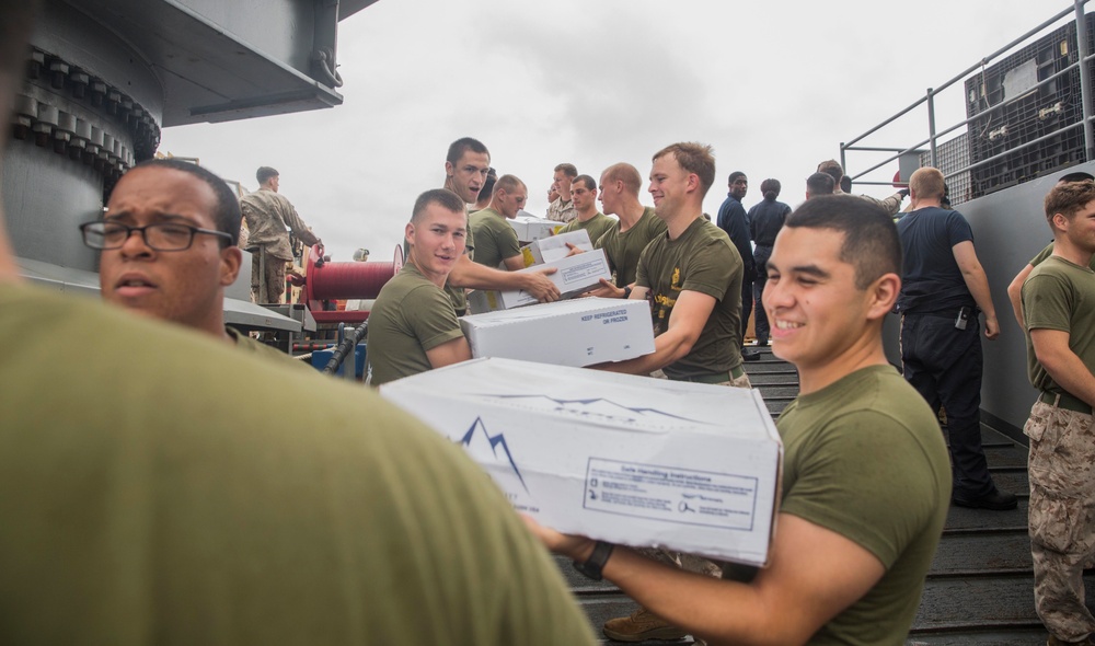 U.S. Marines pitch in during replenishment at sea