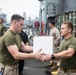 U.S. Marines pitch in during replenishment at sea