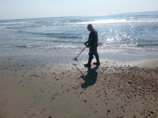 Army civilians clear explosive components from beach