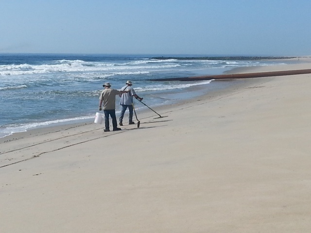 Army civilians clear explosive components from beach