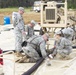 Soldiers clear water away from fuel line couplings