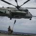 U.S. Marines fast rope from CH-53E Super Stallion at Sea