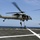 Maritime Raid Force, 26th MEU conducts VBSS training A U.S. Navy helicopter designated HSC-28 hovers over a ship's flight deck while military personnel conduct a fast-rope insertion/extraction (FRIE) exercise. Soldiers are rappelling down ropes from the open cabin door while a ground handler on the deck signals with outstretched arms. The scene takes place on what appears to be a naval vessel at sea under clear blue skies.