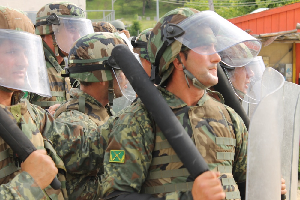 Watching for movement, Albanian army takes part in crowd riot control exercise