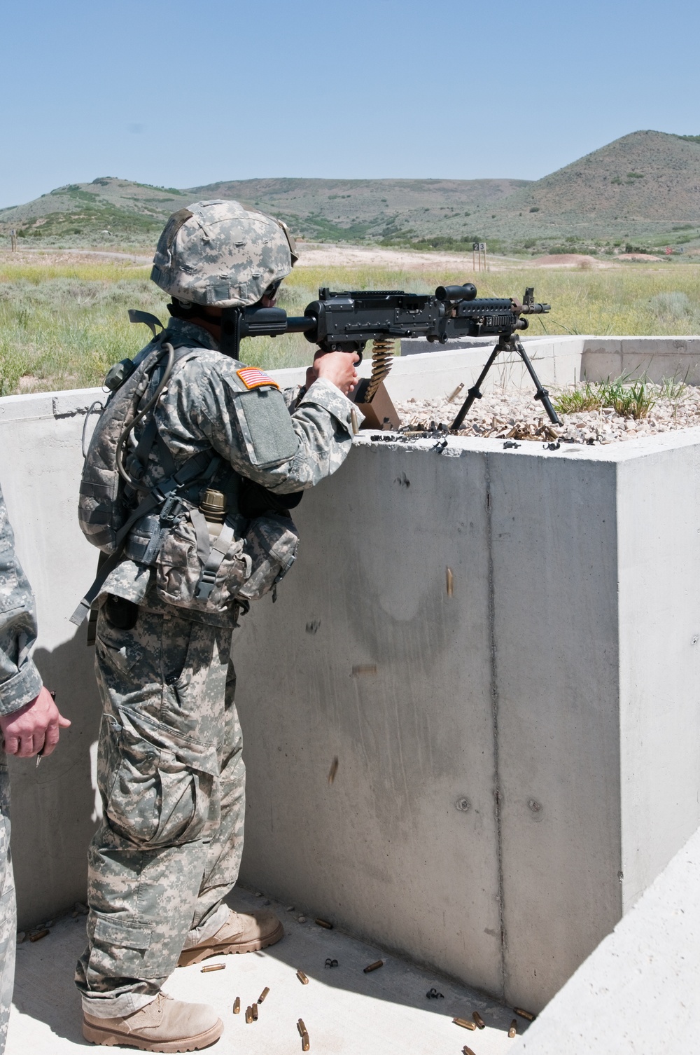 Soldiers and NCOs shoot and move during the Range Run event of the 2015 National Guard Best Warrior Competition