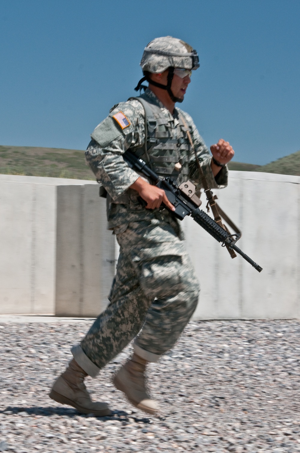 Soldiers and NCOs shoot and move during the Range Run event of the 2015 National Guard Best Warrior Competition