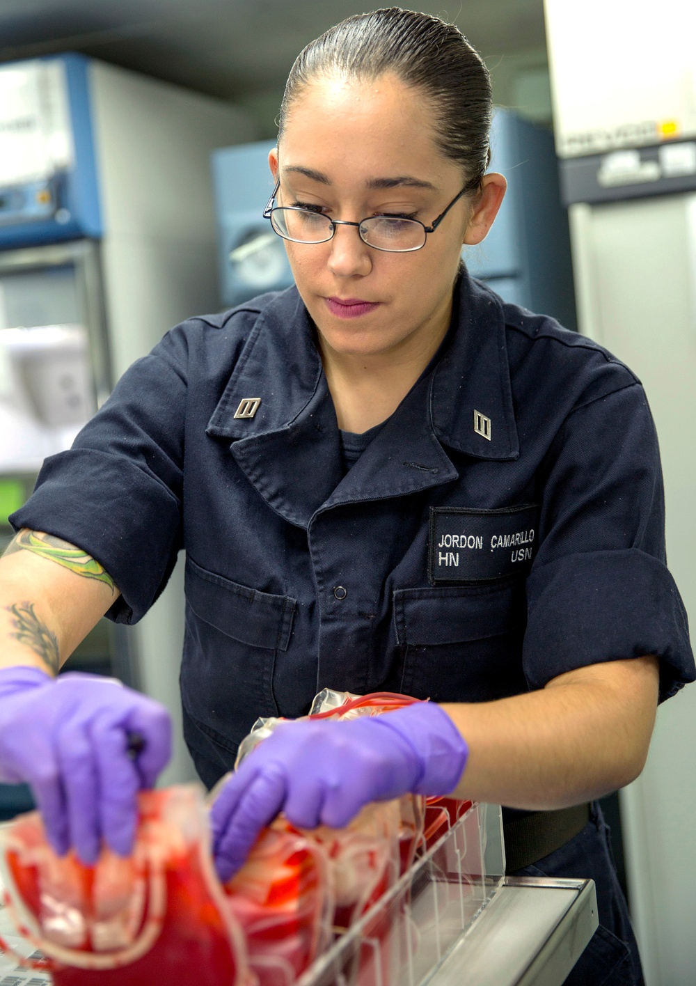 USNS Mercy medical personnel prepare simulated blood for mass casualty drill