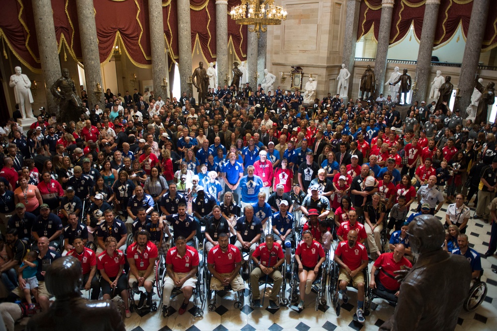 Athletes participating in the 2015 Department of Defense (DoD) Warrior Games take a photo with congressmen during a tour of the U.S. Capitol