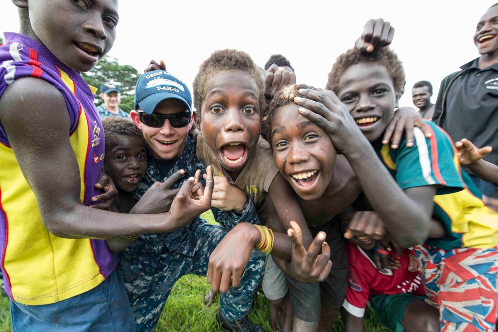 Pacific Partnership Sailors from USNS Mercy interact with local children during their arrival in Arawa, Papua New Guinea