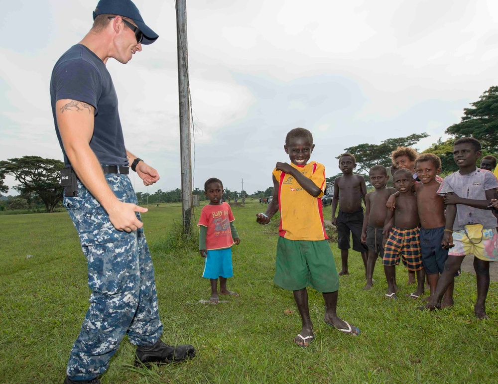 Pacific Partnership Sailors from USNS Mercy interact with local children during their arrival in Arawa, Papua New Guinea