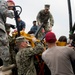 Navy Seabees and Air Force RED HORSE engineers unload a ship during Pacific Partnership