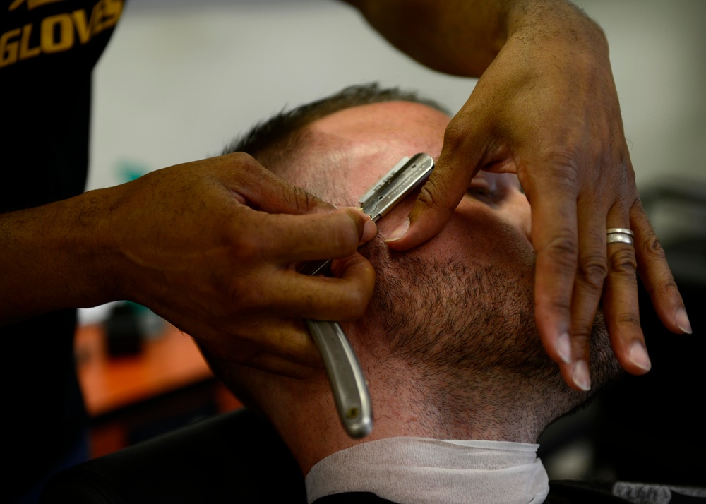 Local barber aims high, credits past