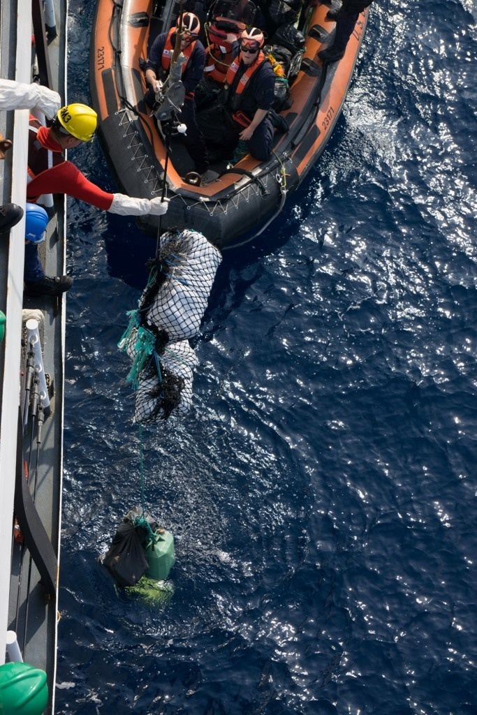 Coast Guardsmen from the Cutter Midgett transfer of 1,760 pounds cocaine