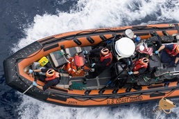 A small boat crew returns to Cutter Midgett with 1,628 pounds of cocaine