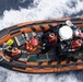 A small boat crew returns to Cutter Midgett with 1,628 pounds of cocaine