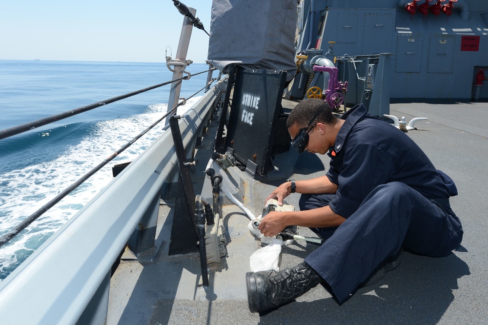 Sailors at work aboard USS Laboon